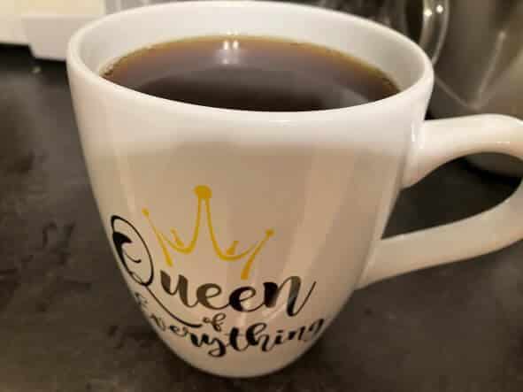 picture of a coffee mug that reads: queen of everything.