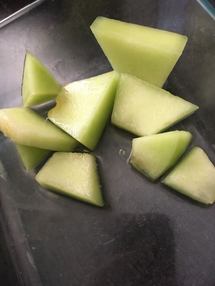 picture of some cut up melon pieces in a container