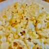 close up of vegan popcorn in a bowl on a wood table